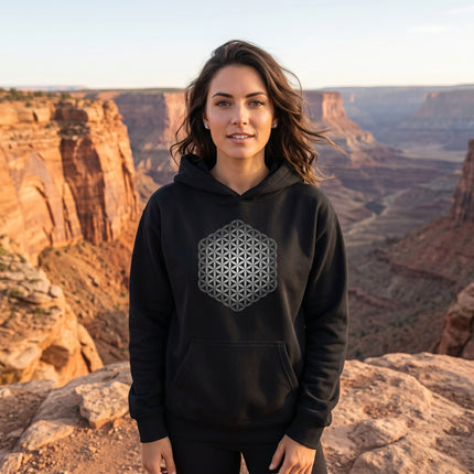 Black hoodie featuring a sacred geometry Flower of Life graphic. Unisex pullover apparel.