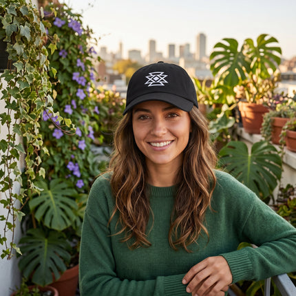 Embroidered black baseball cap featuring a geometric Native American butterfly design.