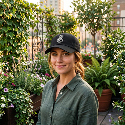 Black baseball cap featuring embroidered Celtic knotwork dragon design.