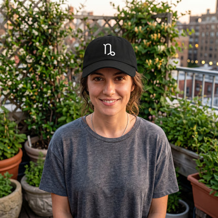 Embroidered Capricorn zodiac symbol on a black baseball cap.