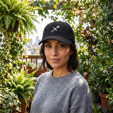 Black baseball cap with embroidered Sagittarius zodiac symbol.