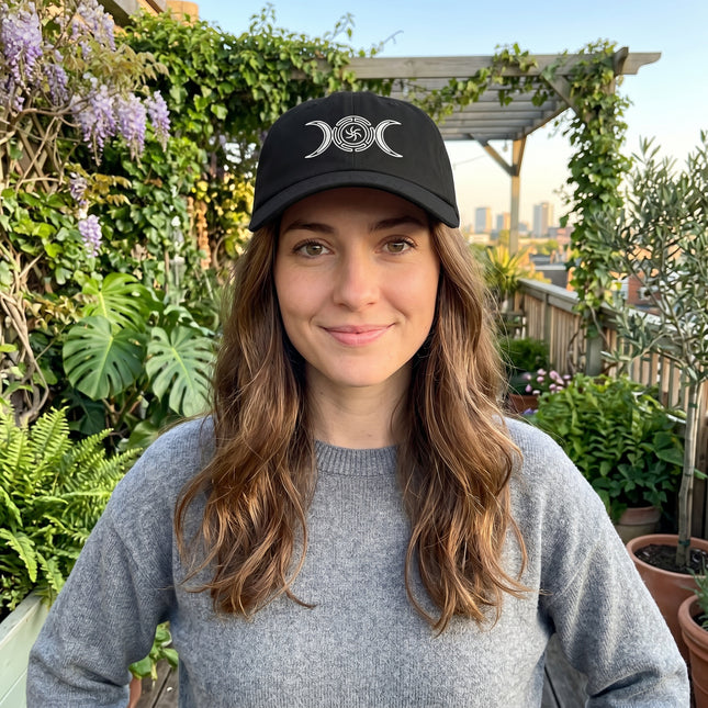 Black embroidered dad hat featuring the Triple Moon symbol of Hecate.