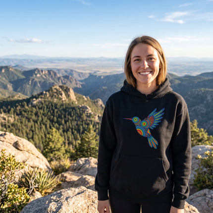 Huichol hummingbird art graphic on a black pullover hoodie. Vibrant indigenous design.