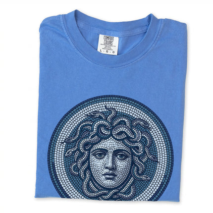 Blue Medusa mosaic graphic tee featuring Greek mythology gorgon head art on a blue shirt.