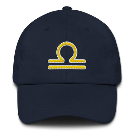 Yellow baseball cap featuring an embroidered Libra zodiac symbol design.