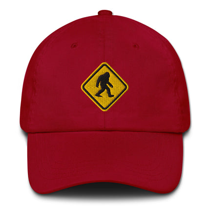 Embroidered Bigfoot crossing sign hat featuring a sasquatch warning symbol design cap.