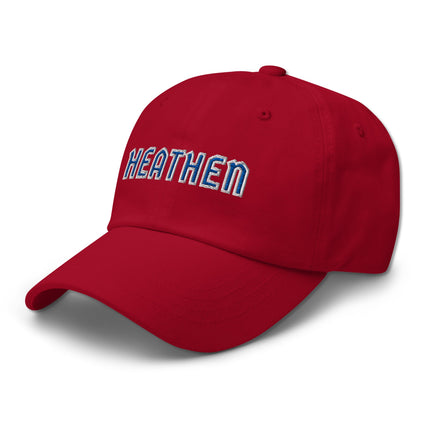 Blue and white unstructured dad hat with embroidered "Heathen" text design.