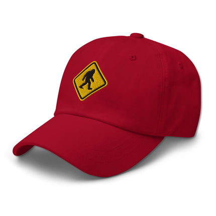 Embroidered Bigfoot crossing sign cap with sasquatch warning symbol design.