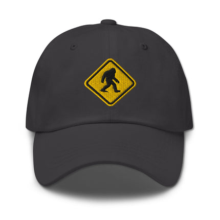 Embroidered Bigfoot crossing sign cap with Sasquatch warning symbol design.