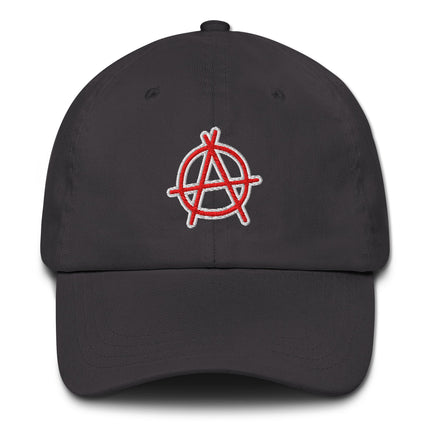 Red baseball cap with embroidered circular anarchy symbol logo.
