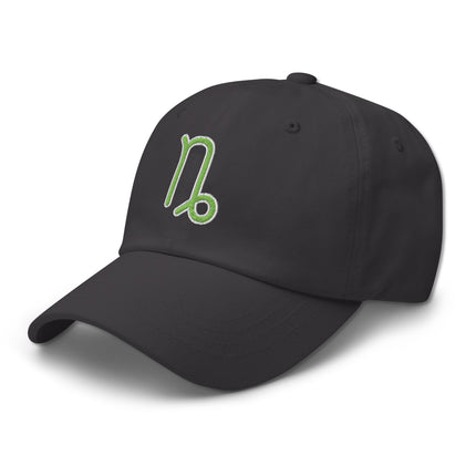 Green baseball cap with embroidered Capricorn zodiac sign symbol.