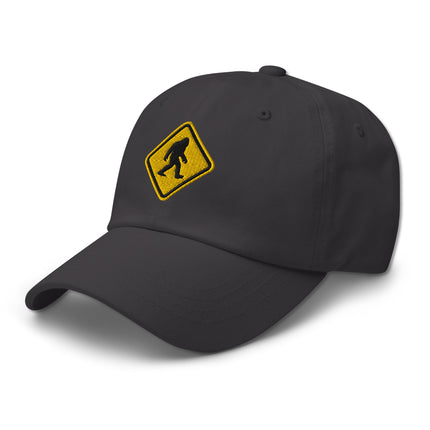 Embroidered cap featuring Bigfoot and Sasquatch crossing warning signs.