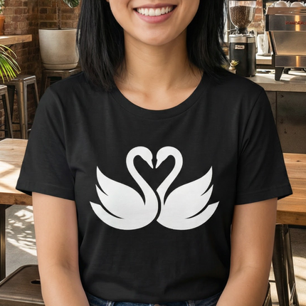 White swan graphic forming a heart on a black t-shirt.