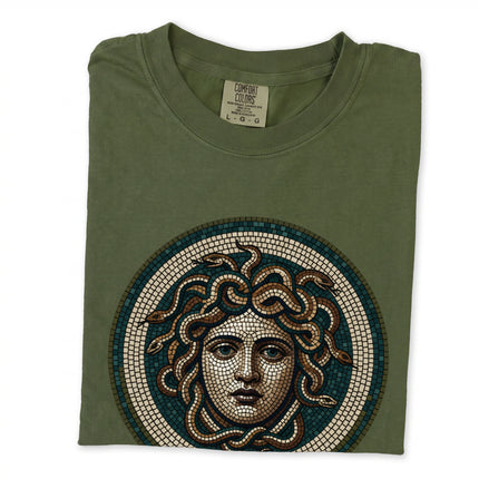 Blue t-shirt with a mosaic graphic of Medusa, the Greek mythology gorgon head design.