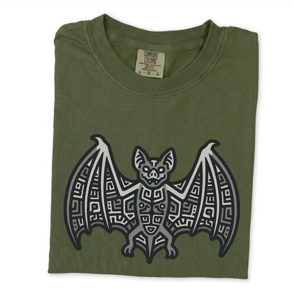 Blue indigo t-shirt with tribal geometric design featuring the Mayan bat symbol graphic.