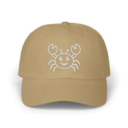 Embroidered cartoon crab and sea life design on a tan baseball cap.