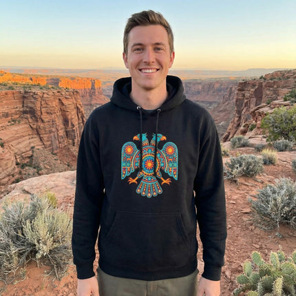 Vibrant Huichol two-headed eagle graphic on a black pullover hoodie, featuring Mexican folk art.