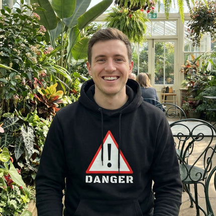 Graphic black hoodie featuring a bold red and white DANGER warning sign graphic.