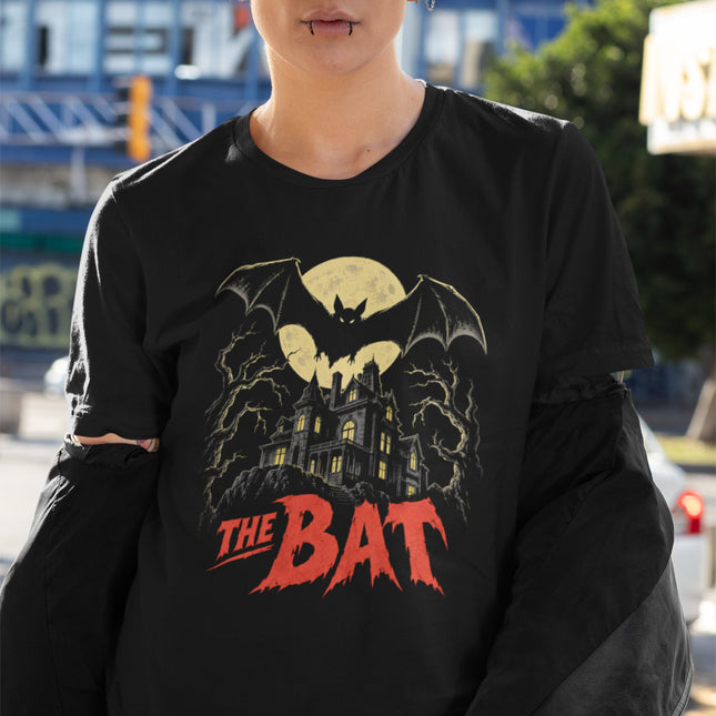 Vintage horror t-shirt featuring a bat and a moonlit mansion poster art design.