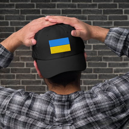 Black embroidered baseball cap featuring the Ukrainian flag design for support.