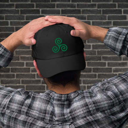 Green baseball cap with embroidered Celtic Triskelion symbol. Irish heritage style headwear.