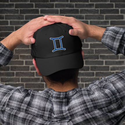 Blue baseball cap with embroidered Gemini zodiac symbol for astrology fans.
