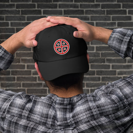 Red embroidered dad hat featuring a prominent solar cross sun symbol design on the front.