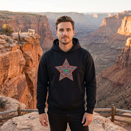 Black hoodie with vibrant Huichol star geometric indigenous art print.