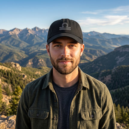 Black baseball cap with embroidered Libra zodiac scales symbol.