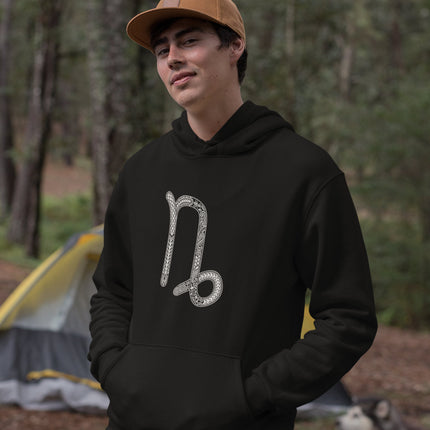 Ornate Capricorn zodiac symbol on a black astrology pullover hoodie.