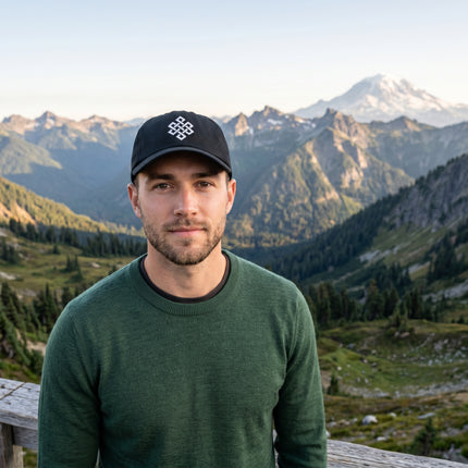 Embroidered Endless Knot symbol on a black baseball cap.