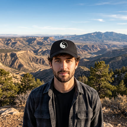 Black baseball cap featuring embroidered Yin and Yang symbol.
