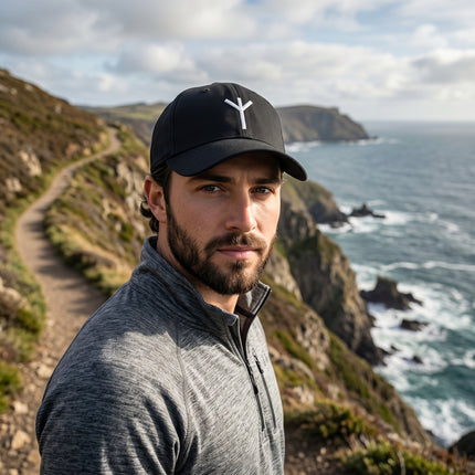 Black baseball cap featuring the embroidered Algiz Rune, a Norse protection symbol.