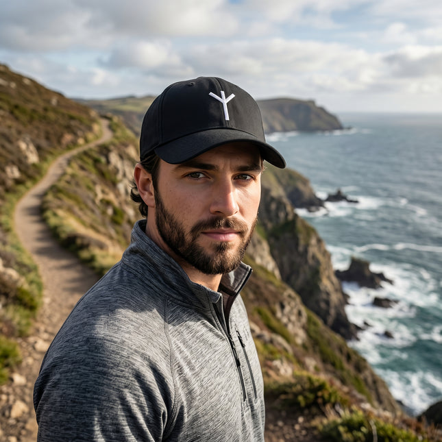 Black baseball cap featuring the embroidered Algiz Rune, a Norse protection symbol.