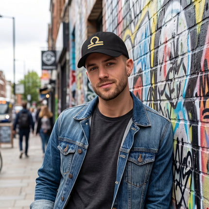 Black baseball cap featuring embroidered Libra zodiac sign embroidery.
