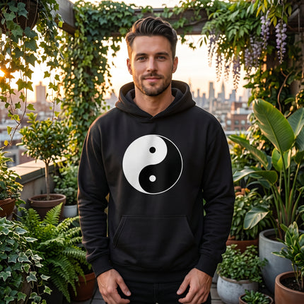 Black hoodie featuring a white Yin Yang symbol graphic. Zen balance streetwear apparel.