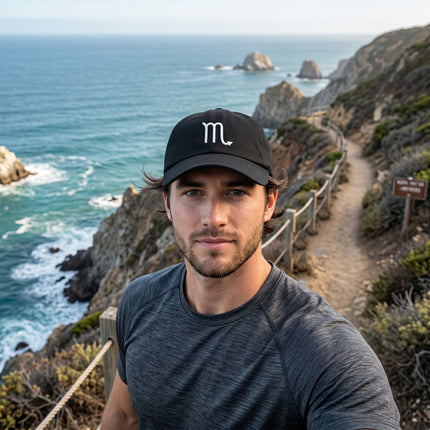 Embroidered Scorpio zodiac symbol on a black baseball cap. Minimalist astrology hat.