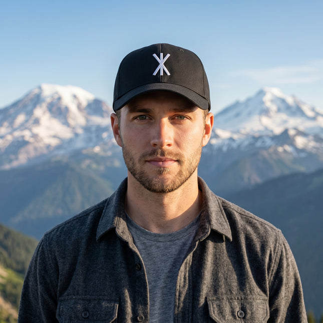 Black baseball cap with white embroidered Strength Rune sigil. Norse mythology streetwear accessory.