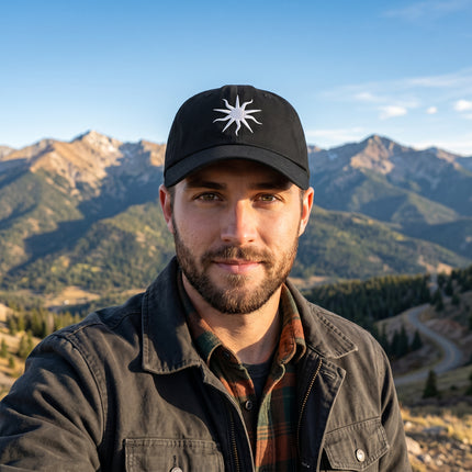 Black baseball cap with embroidered occult sun symbol.