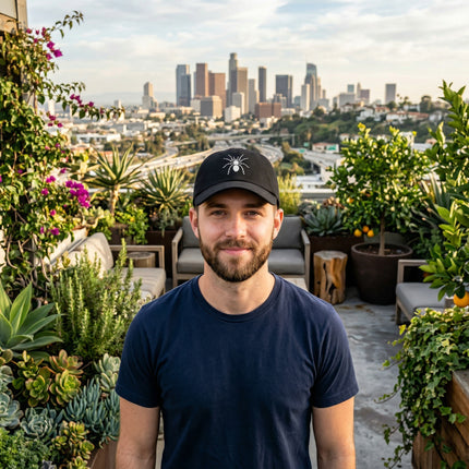 Black baseball cap featuring an embroidered tarantula spider design.