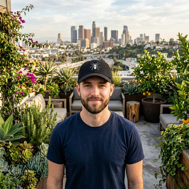 Black baseball cap featuring an embroidered tarantula spider design.