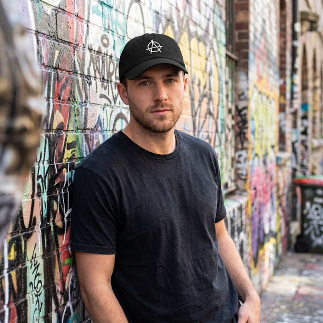 Black baseball cap featuring an embroidered anarchy symbol.