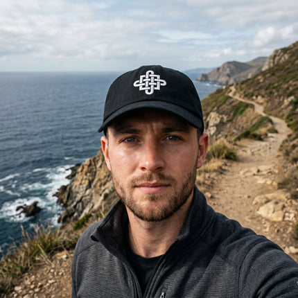 Black dad hat with white embroidered Celtic Cross knotwork symbol.