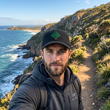 Green embroidered Celtic knot cross on a black baseball cap. Unisex design.