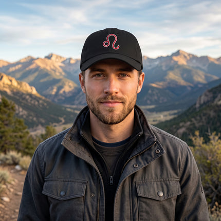 Black baseball cap featuring red embroidered Leo zodiac symbol.