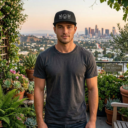 Black snapback hat featuring embroidered rock emoji and pop culture designs.