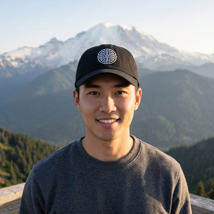 Black baseball cap featuring the embroidered Chinese Cai wealth symbol for good fortune.
