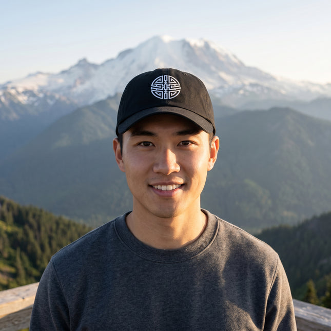 Black baseball cap featuring the embroidered Chinese Cai wealth symbol for good fortune.