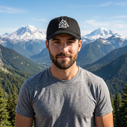 Black baseball cap with white embroidered Valknut symbol, Norse warrior knot design.