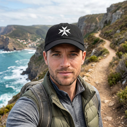 Black baseball cap featuring a white embroidered Maltese Cross symbol.